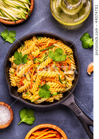 Fusilli pasta with squid, zucchini and carrots Fusilli pasta with squid, zucchini and carrots 44074781