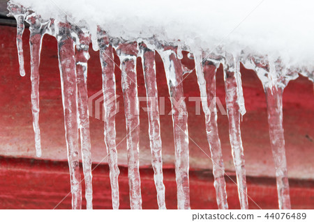 Icicles hanging from roof Icicles hanging from roof 44076489