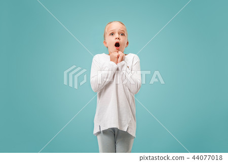 Portrait of the scared girl on blue Portrait of the scared girl on blue 44077018