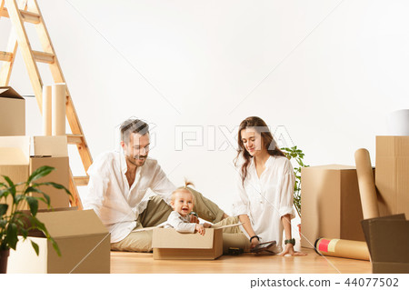 Couple moving to a new home - Happy married people buy a new apartment to start new life together Couple moving to a new home - Happy married people buy a new apartment to start new life together 44077502