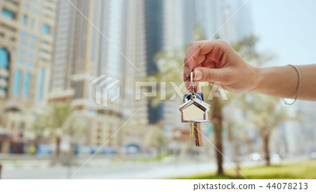 Hand girl holds the keys. The concept of buying an apartment or car in Dubai. Hand close-up. Hand girl holds the keys. The concept of buying an apartment or car in Dubai. Hand close-up. 44078213