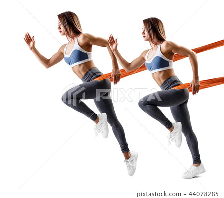 Young sporty woman using a resistance band. Young sporty woman using a resistance band. 44078285
