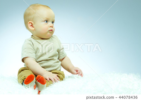 Cute beautiful newborn on a blue background. Copy space Cute beautiful newborn on a blue background. Copy space 44078436