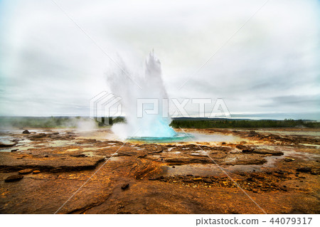 Geyser eruption in a beautifil Iceland landscape. 44079317