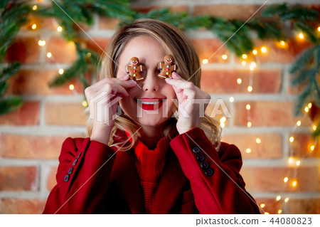 girl in red coat with gingerbread man girl in red coat with gingerbread man 44080823