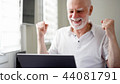 Handsome elderly senior man working on laptop computer at home. Received good news excited and happy 44081791