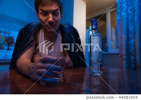 Alcohol addicted man sitting in kitchen at home. 44081959