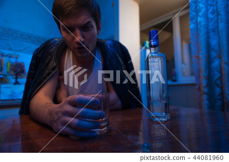Alcohol addicted man sitting in kitchen at home. 44081960