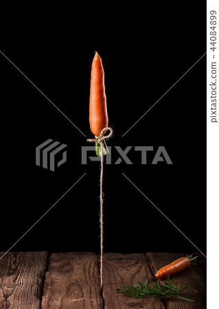 Carrot launches like a rocket on black background. 44084899