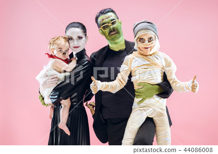 Halloween Family. Happy Father, Mother and Children Girls in Halloween Costume and Makeup Halloween Family. Happy Father, Mother and Children Girls in Halloween Costume and Makeup 44086008