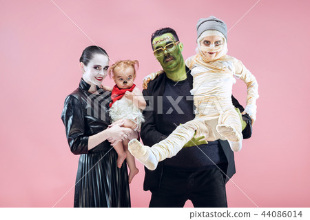 Halloween Family. Happy Father, Mother and Children Girls in Halloween Costume and Makeup Halloween Family. Happy Father, Mother and Children Girls in Halloween Costume and Makeup 44086014