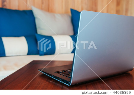 Vacation working, Laptop computer on wood table Vacation working, Laptop computer on wood table 44086599