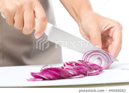 Cook is chopping onion Cook is chopping onion 44088082