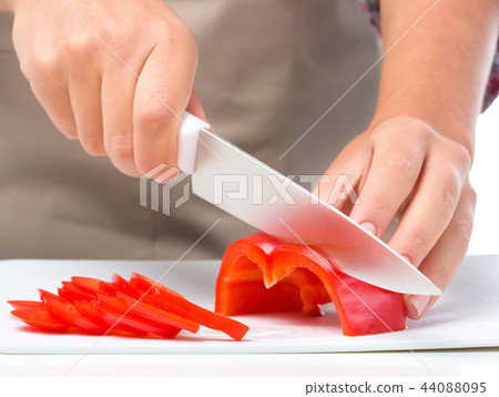 Cook is chopping bell pepper Cook is chopping bell pepper 44088095