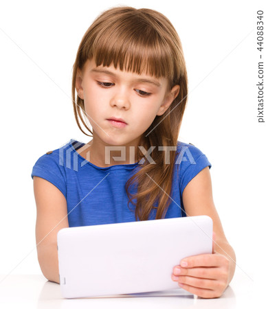 Young girl is using tablet Young girl is using tablet 44088340