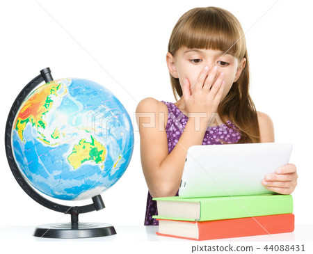 Young girl is using tablet while studying Young girl is using tablet while studying 44088431