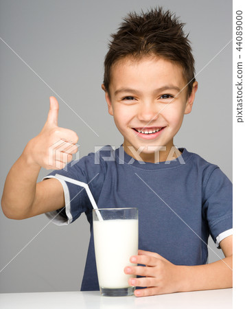 Cute boy with a glass of milk Cute boy with a glass of milk 44089000