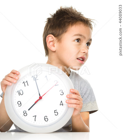 Boy is holding big clock Boy is holding big clock 44089033