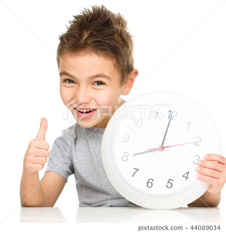 Boy is holding big clock Boy is holding big clock 44089034
