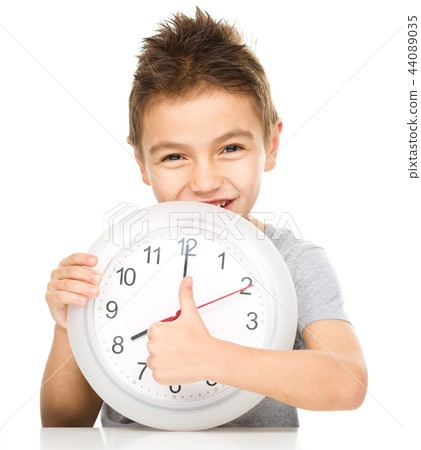 Boy is holding big clock Boy is holding big clock 44089035