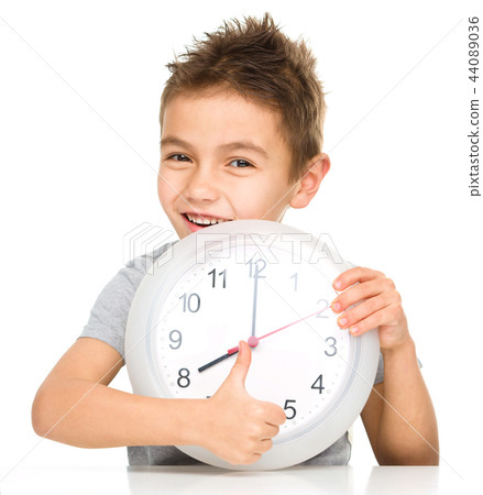 Boy is holding big clock Boy is holding big clock 44089036