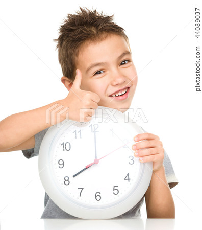 Boy is holding big clock Boy is holding big clock 44089037