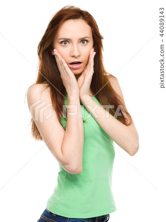 Woman is holding her face in astonishment 44089143