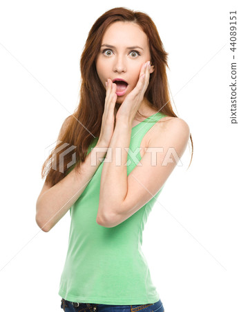 Woman is holding her face in astonishment Woman is holding her face in astonishment 44089151