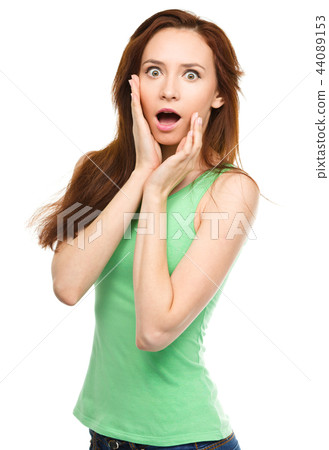 Woman is holding her face in astonishment Woman is holding her face in astonishment 44089153