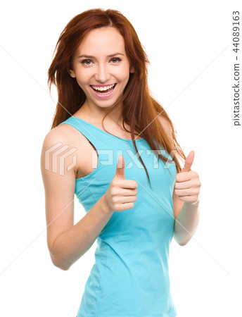 Woman is showing thumb up gesture Woman is showing thumb up gesture 44089163