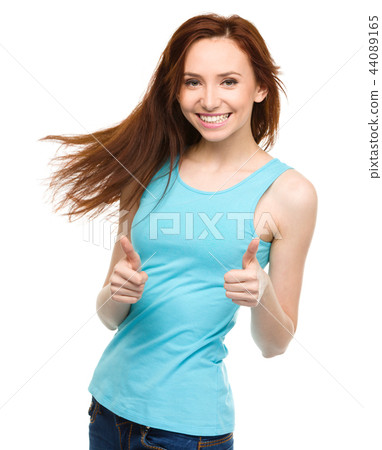 Woman is showing thumb up gesture 44089165