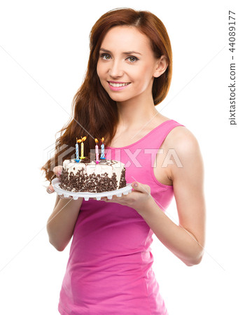 Young woman with anniversary cake Young woman with anniversary cake 44089177