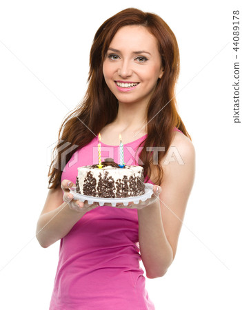 Young woman with anniversary cake Young woman with anniversary cake 44089178