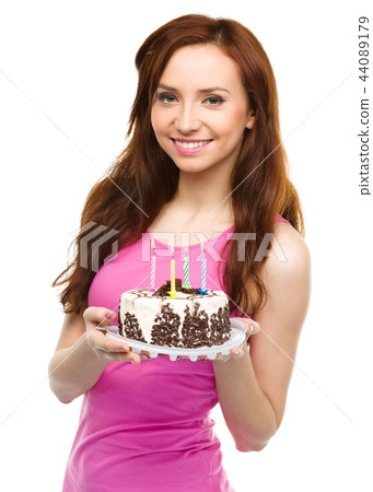 Young woman with anniversary cake 44089179