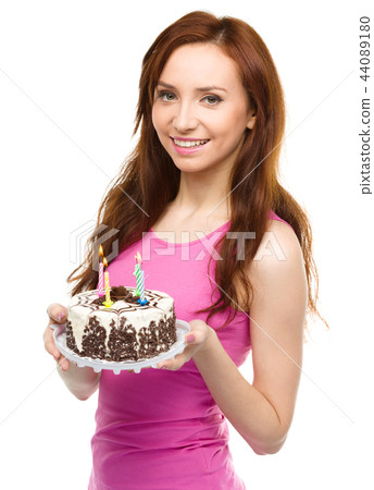 Young woman with anniversary cake Young woman with anniversary cake 44089180