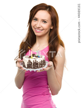 Young woman with anniversary cake Young woman with anniversary cake 44089181