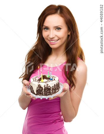 Young woman with anniversary cake Young woman with anniversary cake 44089182