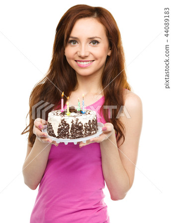 Young woman with anniversary cake Young woman with anniversary cake 44089183