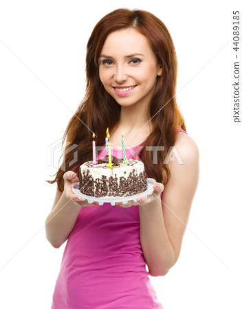 Young woman with anniversary cake Young woman with anniversary cake 44089185