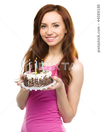 Young woman with anniversary cake 44089186