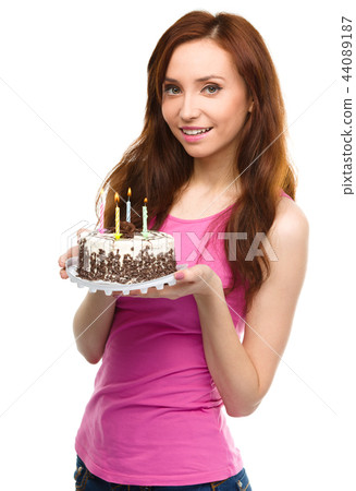 Young woman with anniversary cake Young woman with anniversary cake 44089187