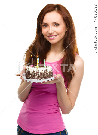 Young woman with anniversary cake Young woman with anniversary cake 44089188