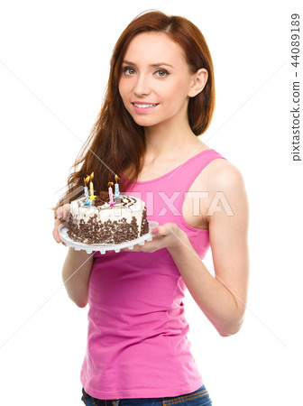 Young woman with anniversary cake Young woman with anniversary cake 44089189