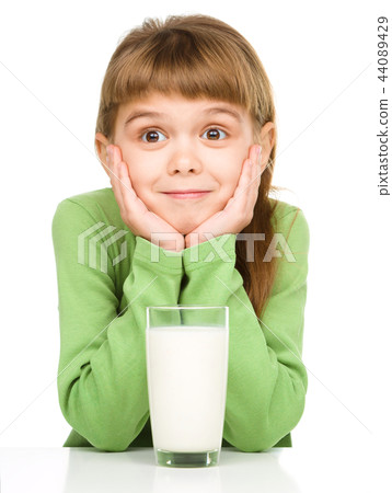 Cute little girl with a glass of milk Cute little girl with a glass of milk 44089429