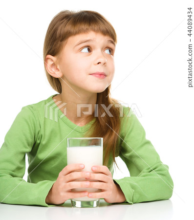 Cute little girl with a glass of milk Cute little girl with a glass of milk 44089434