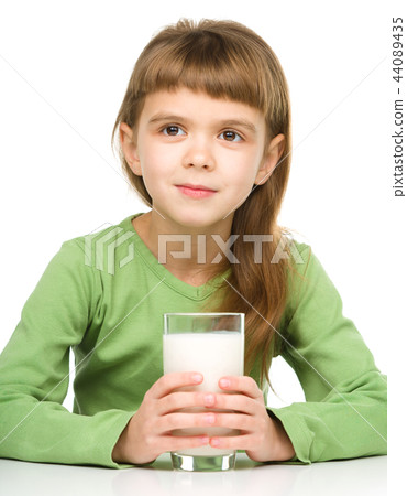 Cute little girl with a glass of milk 44089435