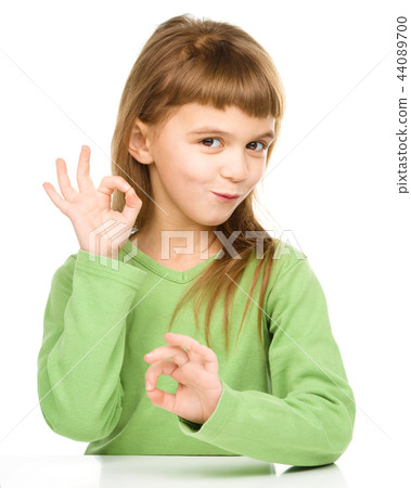 Happy little girl is showing OK sign 44089700