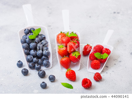 Fresh raw organic berries in white scoop spoon Fresh raw organic berries in white scoop spoon 44090141