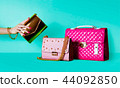 Colorful bags. Golden party bag and pink rose 44092850