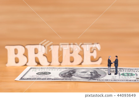 The concept about corruption. Miniature people and money 44093649